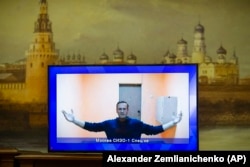 Aleksei Navalny appears on a TV screen during a court hearing in Moscow on January 28, 2021.