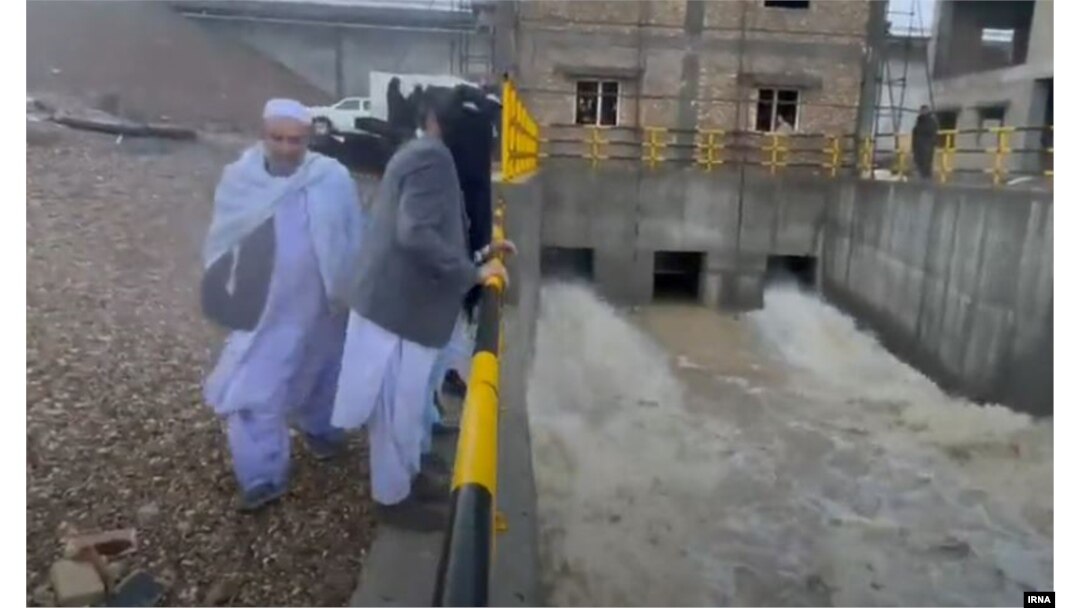 Bystanders watch water being released from the Kamal Khan Dam in Afghanistan on January 20.