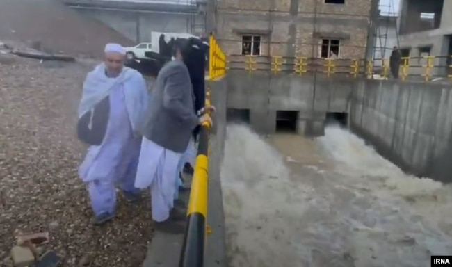 Bystanders watch water being released from the Kamal Khan Dam in Afghanistan on January 20.