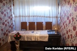 Zurab Chichoshvili's coffin lies in his tiny room at the Kartli sanatorium.