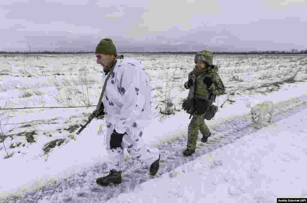 Ukrainian soldiers walk at the line of separation from Russia-backed separatists in the Donetsk region of eastern Ukraine.