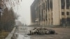 KAZAKHSTAN -- This general view shows a vehicle in front of a burnt-out administrative building in central Almaty on January 7, 2022, after violence that erupted following protests over hikes in fuel prices. -