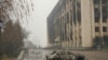 KAZAKHSTAN -- This general view shows a vehicle in front of a burnt-out administrative building in central Almaty on January 7, 2022, after violence that erupted following protests over hikes in fuel prices. -