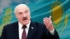 Lukashenka with the flag of Kazakhstan background