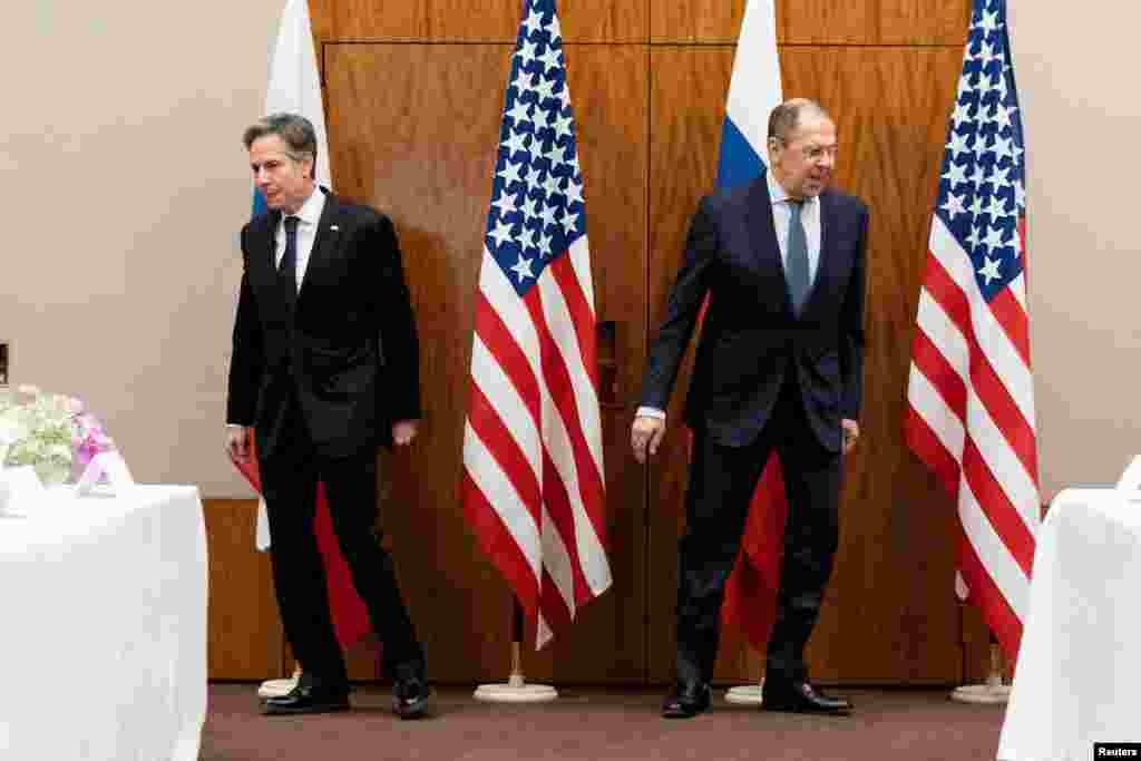 U.S. Secretary of State Antony Blinken (left) and Russian Foreign Minister Sergei Lavrov move to their seats before their meeting in Geneva on January 21.&nbsp;