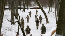 Членове на доброволен военен отряд към украинските въоръжени сили провеждат обучение в парк в Киев, 22 януари 2022.