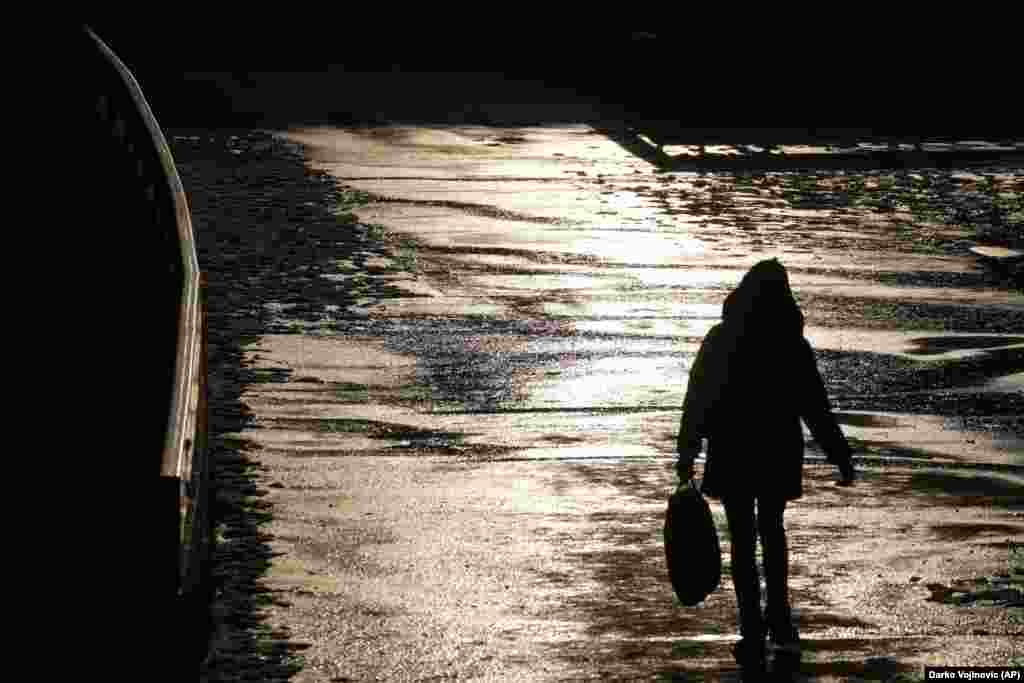 A woman walks in the Serbian capital, Belgrade, on a sunny winter&#39;s day on January 27.&nbsp;