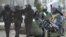 Сілавікі падчас разгону пратэстаў у Казахстане (зьлева) і Беларусі