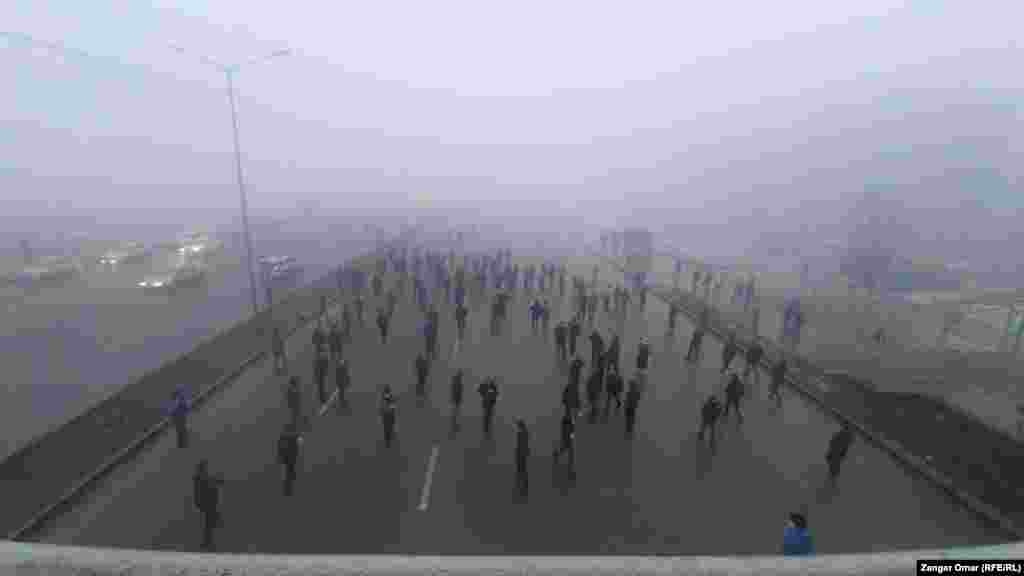 Demonstrators walk along Almaty&#39;s central Rayimbek Avenue on January 5.&nbsp;