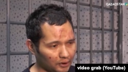 Скриншот с видео, где Викрам Рузахунов, с синяками на лице, признается в погромах.