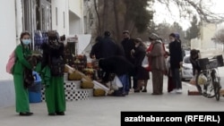 Turkmen line up outside a grocery shop to buy food in the capital, Ashgabat. 