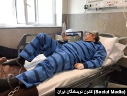 Baktash Abtin is shown shackled to his hospital bed in July 2021.