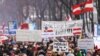 Demonstrators hold flags and placards as they march to protest against the coronavirus disease (COVID-19) restrictions and the vaccine mandate in Vienna, Austria, December 11, 2021. REUTERS/Lisi Niesner