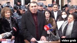 Armenia - Aharon Khachatrian is sworn in as mayor of Vartenis outside the municipal administration building cordoned off by police, January 4, 2022.