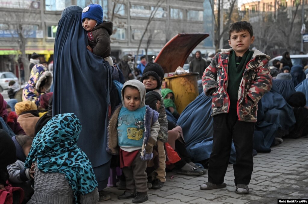 Disa fëmijë duke pritur për të marrë një bukë falas, para një furre, në Kabul, Afganistan, më 24 janar.