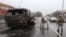 Security forces stand guard near a burned truck while checking vehicles in Kazakhstan's largest city, Almaty, on January 8.
