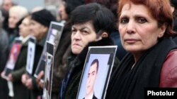 Armenia -- Relatives hold up pictures of Armenians killed in the March 2008 clashes in Yerevan during an opposition rally.