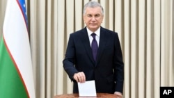Uzbek President Shavkat Mirziyoev casts his ballot in a constitutional referendum in Tashkent on April 30. 