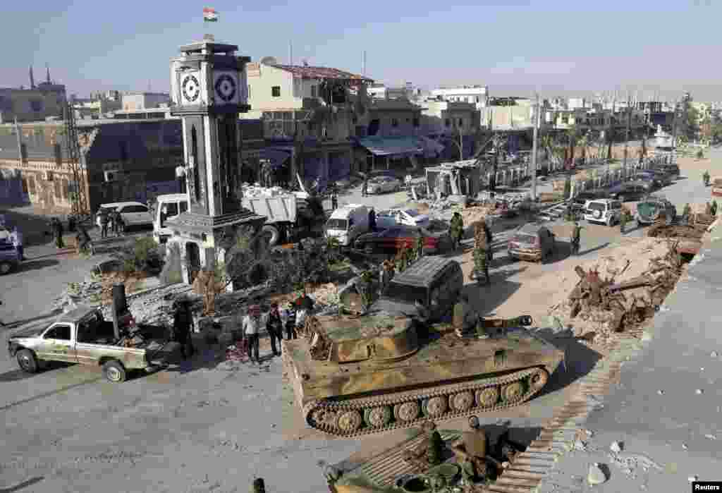 Soldiers loyal to the Syrian regime are seen in Qusayr, after the Syrian Army took control of the city from rebel fighters. Syrian government forces and their Lebanese Hizballah allies seized control of the border town on June 5, dealing a major defeat to rebel fighters battling to overthrow President Bashar al-Assad. (Reuters/Mohamed Azakir)