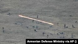 In this image taken from a YouTube footage released by Armenian Defense Ministry on Tuesday, Sept. 13, 2022, shows Azerbaijanian servicemen crossing the Armenian-Azerbaijani border and approaching the Armenian positions.