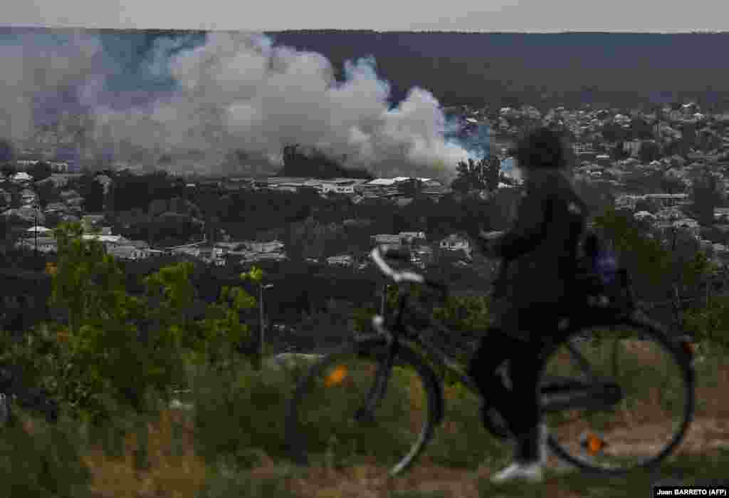 A cyclist looks out over Izyum shortly after its liberation on September 11. The Ukrainian military has pushed Russian forces out of swaths of territory in the northeast of the country.