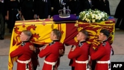 Pallbearers from the Queen's Company, 1st Battalion Grenadier Guards carry the coffin of Queen Elizabeth II into Westminster Hall at the Palace of Westminster in London on September 14.