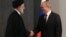 Russian President Vladimir Putin (right) shakes hands with Iranian President Ebrahim Raisi in Samarkand, Uzbekistan, on September 15.