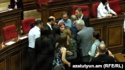 Armenia - Opposition deputies Gegham Manukian and Agnesa Khamoyan are confronted by angry pro-government colleagues on the parliament floor, September 15, 2022.