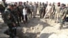 Iraqi forces search the site of a suspected mass grave containing the remains of victims of the Islamic State group last month, southwest of Hawija.