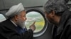 Iranian President Hassan Rohani (L) is seen in a helicopter inspecting the flood-affected villages in Golestan province, March 27, 2019