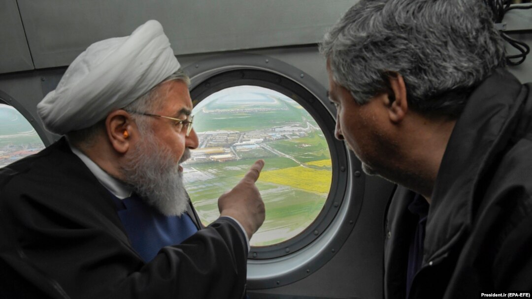 Iranian President Hassan Rohani (left) inspects the flood-affected villages in Golestan Province from a helicopter on March 27.