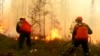 Firefighters work on a site of a forest fire in Yakutia in Russia Far East.
