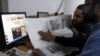 Pakistan -- Pakistani men read a local edition of the International New York Times with a blank space that was supposed to be reporting on the first issue of the French magazine Charlie Hebdo since last week's attack, in Islamabad, January 14, 2015