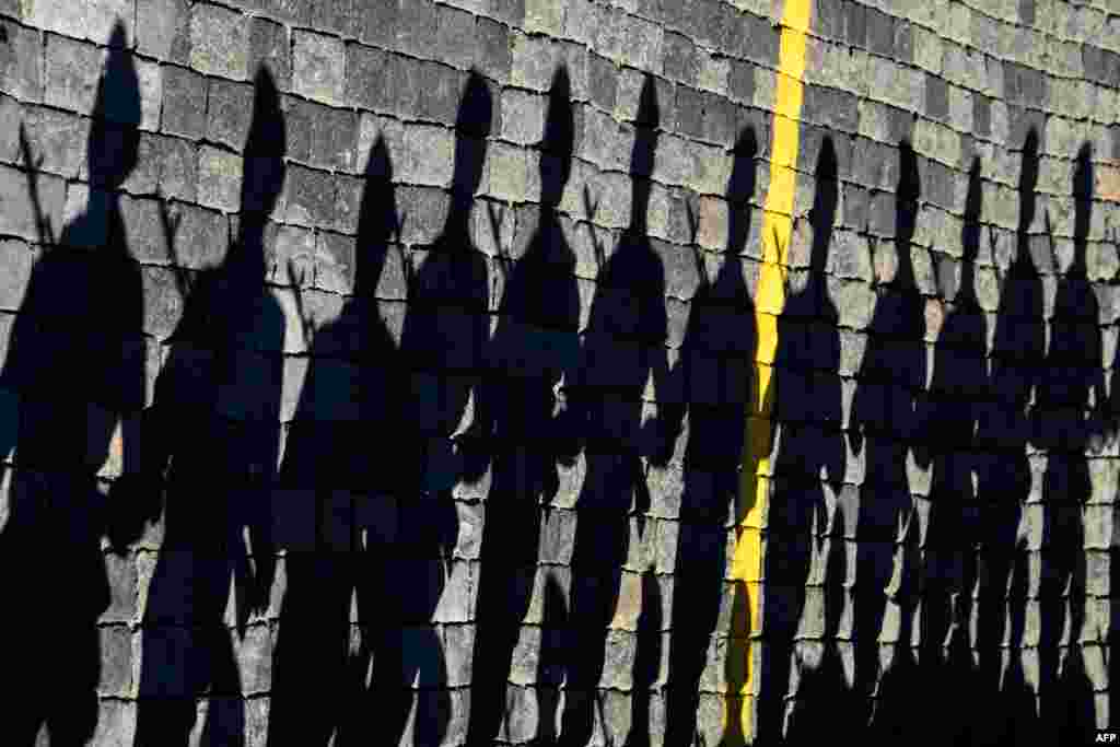 Russian servicemen cast shadows on paving stones on Moscow's Red Square as they take part in a rehearsal for a Victory Day military parade, which is due to take place on May 9. (AFP/Kirill Kudryavtsev)