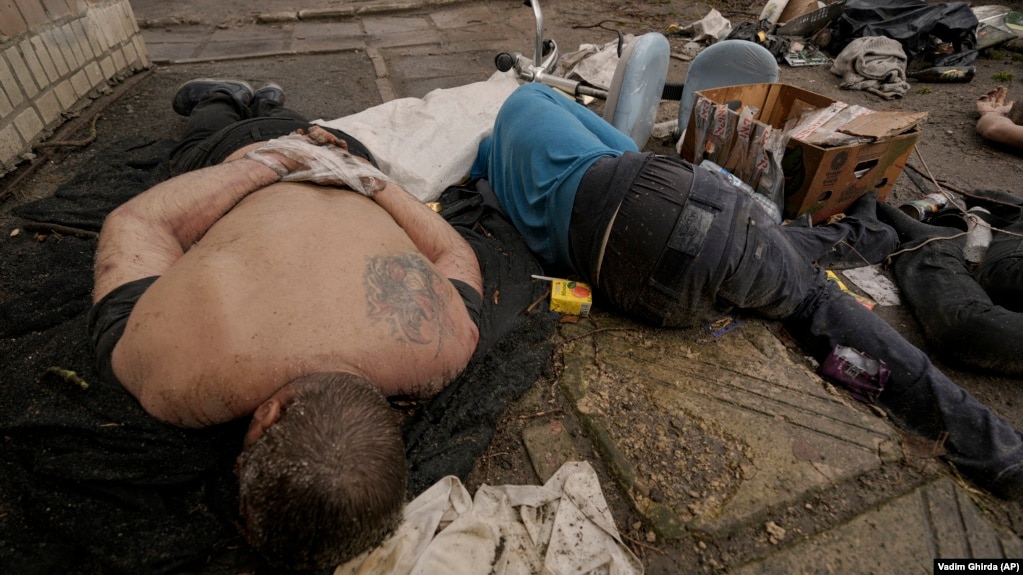 The bodies of men, some with their hands tied behind their backs, lie on the ground in Bucha on April 3. 