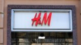 A woman stands next to a closed H&M store in Moscow, Russia March 3, 2022. REUTERS/Staff