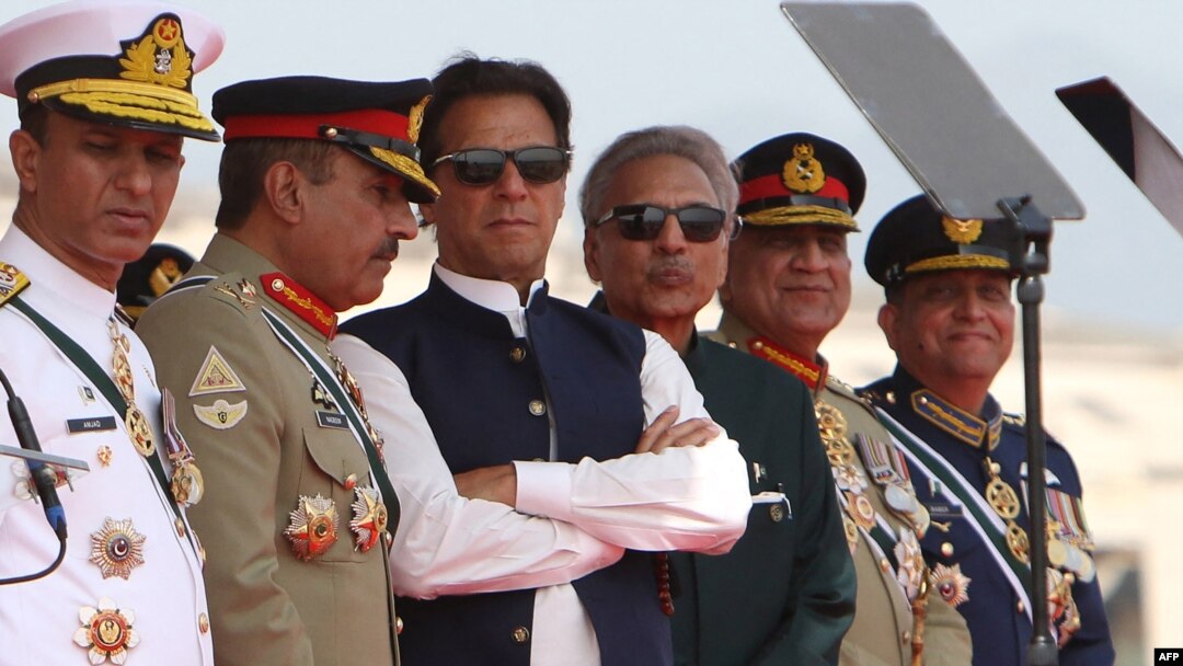 Pakistani Prime Minister Imran Khan (third left) and President Arif Alvi (third right) watch Pakistani Air Force fighter jets perform during a Pakistan Day parade in Islamabad on March 23.
