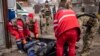 Ukrainian medics remove the body of a Russian soldier after Kyiv's forces retook the village of Mala Rohan, east of Kharkiv, on March 30.