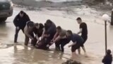 Residents of the city of Aktobe are pulling a fallen girl out of the melt water. March 31, 2022