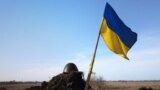 A Ukrainian flag and a helmet of a soldier are pictured at checkpoint, as Russia's invasion of Ukraine continues, in Mykolaiv.