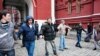 Opposition activists stand near the closed entrance to Red Square.