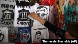 A Yerevan shop owner displays a T-shirt depicting Armenian opposition lawmaker Nikol Pashinian.