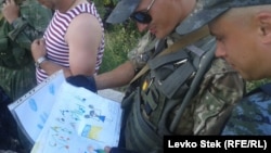 Soldiers enjoy the children's drawings they've received.