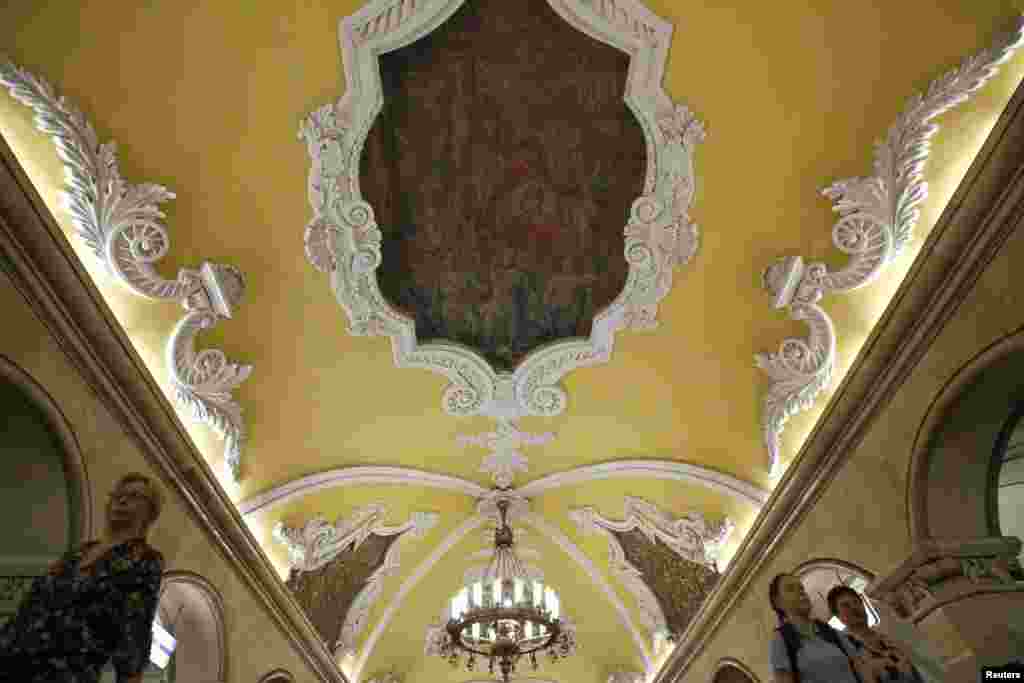 People walk under a mosaic of Lenin at the Komsomolskaya metro station.