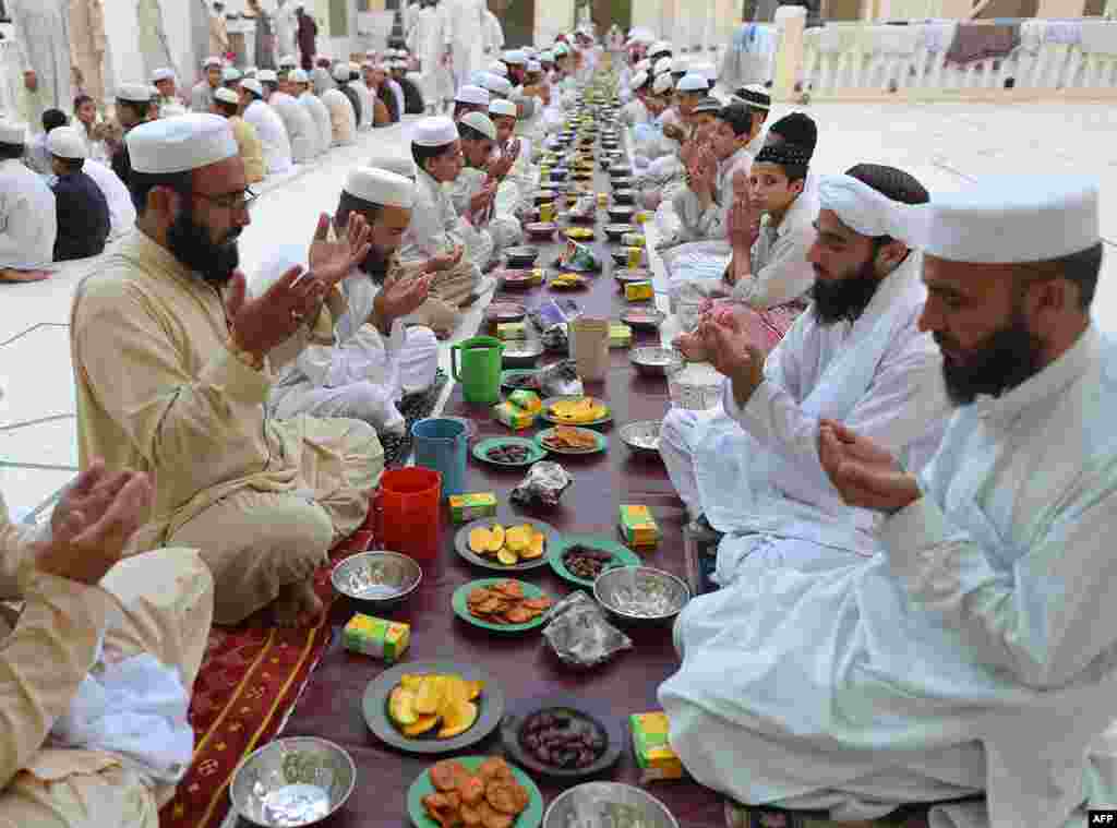 Pakistani Muslims pray before breaking their fast at a mosque during the first day of the Muslim fasting month of Ramadan in Peshawar on July 11. (AFP/A. Majeed)