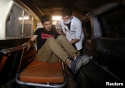 A wounded man is helped by a medic inside an ambulance following the attack.