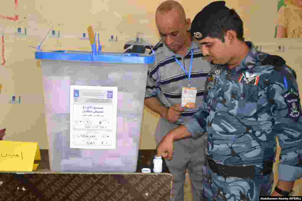 Policemen cast their votes during local elections in Basra.