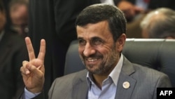 Iranian President Mahmud Ahmadinejad flashes the victory sign as he attends the 12th summit of the Organization of Islamic Cooperation in Cairo on February 6.