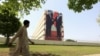 A man walks past a giant portrait of Pakistani Prime Minister Nawaz Sharif (L) and Chinese President Xi Jinping displayed on a building in Islamabad, April 21.