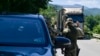 NATO soldiers greet a truck driver near the town of Zubin Potok on August 1. 